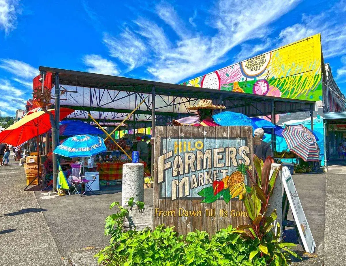 Instagram: the Hilo Farmers Market sign under the umbrellas